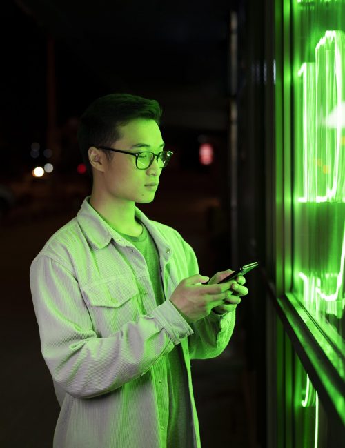 medium-shot-man-holding-smartphone