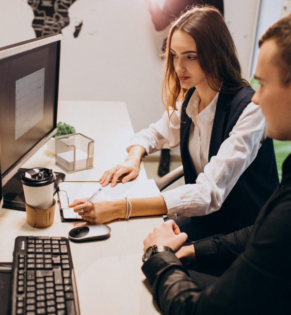 Workers at an IT company working on a computer